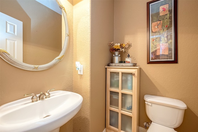 bathroom featuring toilet and sink