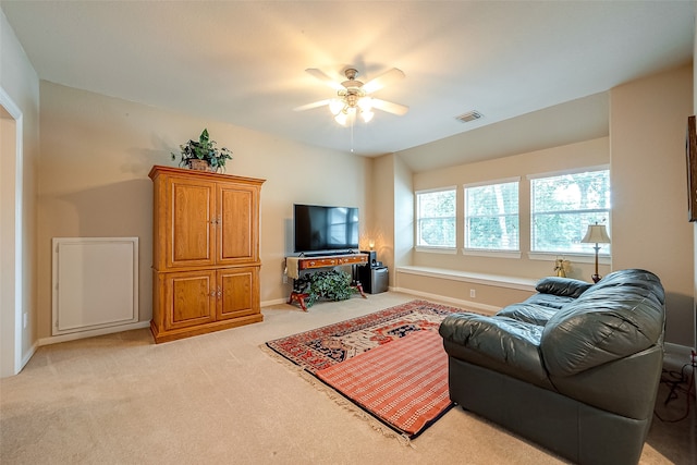 carpeted living room with ceiling fan