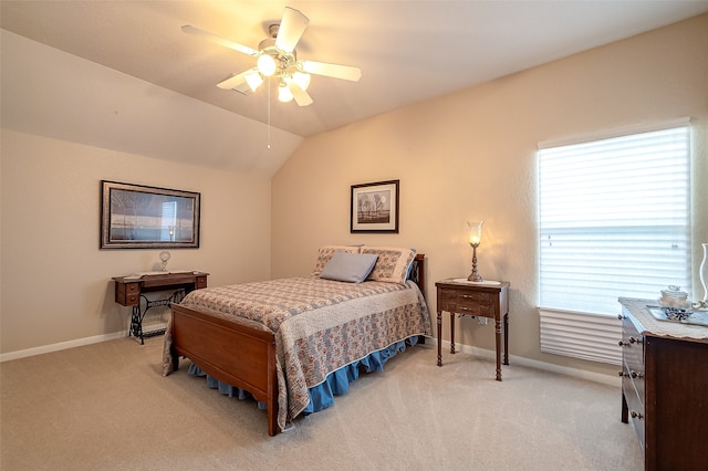 bedroom with multiple windows, ceiling fan, light carpet, and lofted ceiling