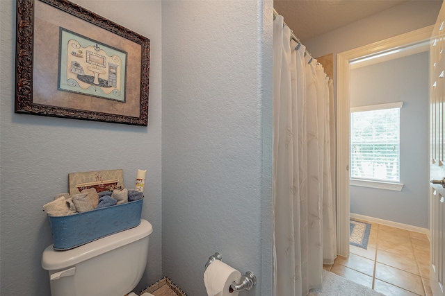 bathroom with tile patterned floors and toilet