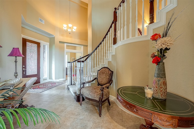 foyer with a towering ceiling and a chandelier