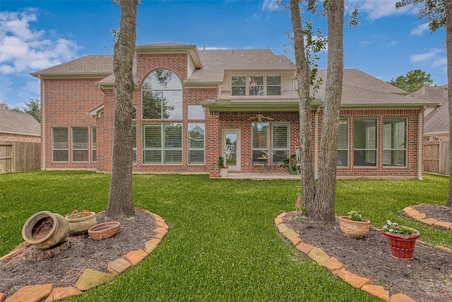 rear view of property featuring a yard and a patio