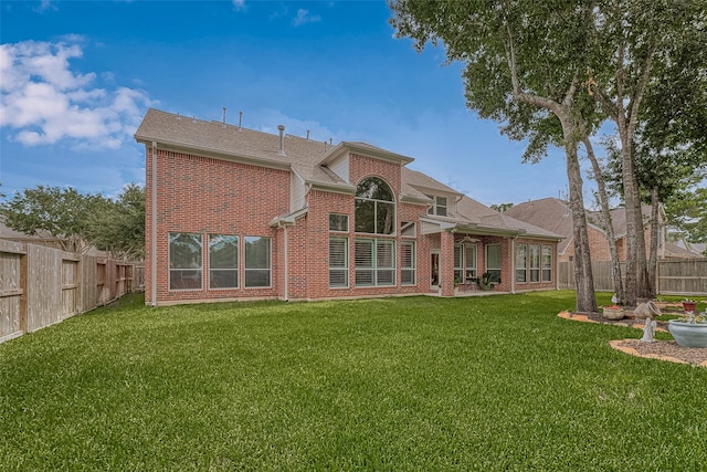 back of house with a lawn