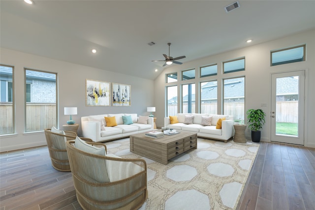 living room with ceiling fan, wood-type flooring, and lofted ceiling