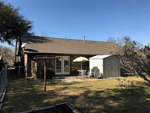 rear view of property featuring a storage shed, a yard, and a patio