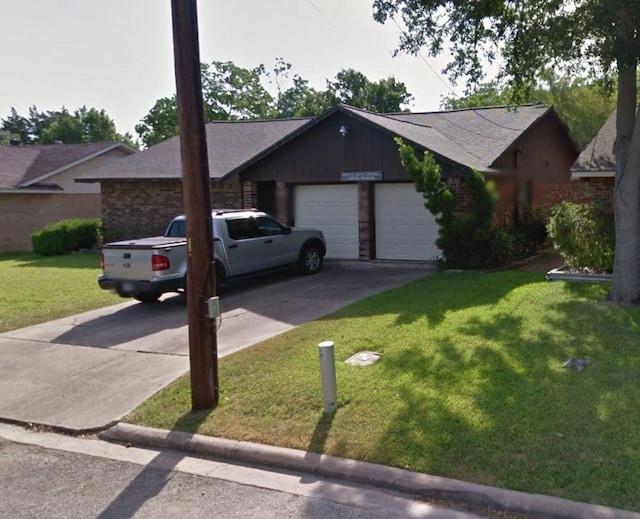 ranch-style house featuring a front yard and a garage