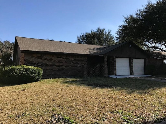 ranch-style home with a garage and a front lawn