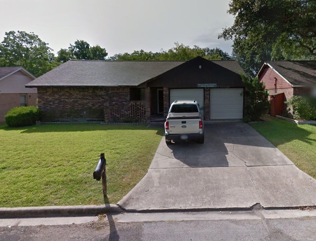 ranch-style house featuring a garage and a front yard