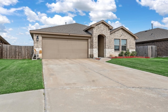 view of front of house with a garage and a front lawn