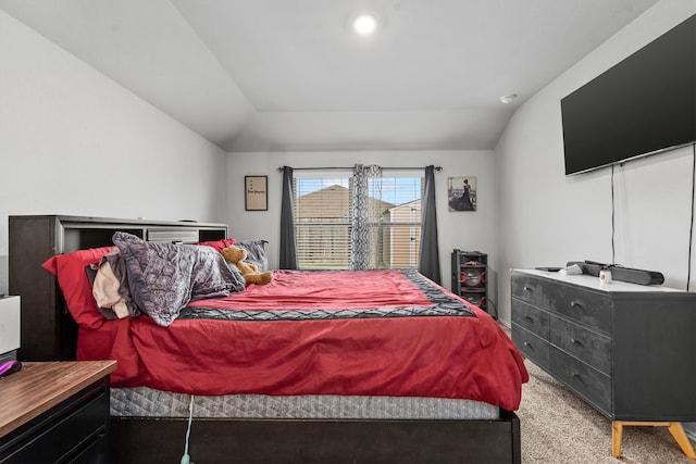 carpeted bedroom with vaulted ceiling