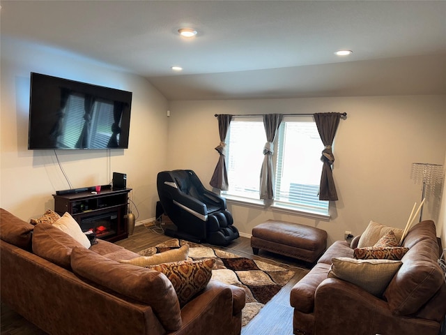 living room with hardwood / wood-style floors and lofted ceiling