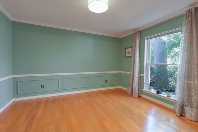 empty room with light hardwood / wood-style flooring and ornamental molding