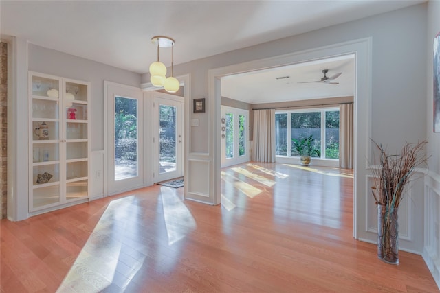 entryway featuring built in shelves, light hardwood / wood-style flooring, and ceiling fan