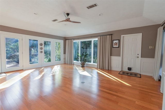 workout area featuring ceiling fan and light hardwood / wood-style floors