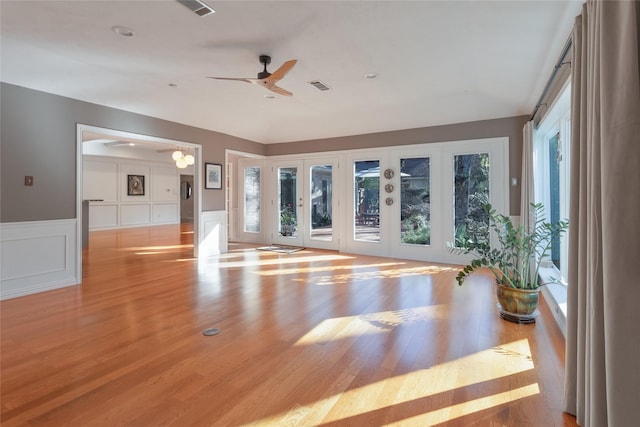 exercise area with ceiling fan, plenty of natural light, and light wood-type flooring