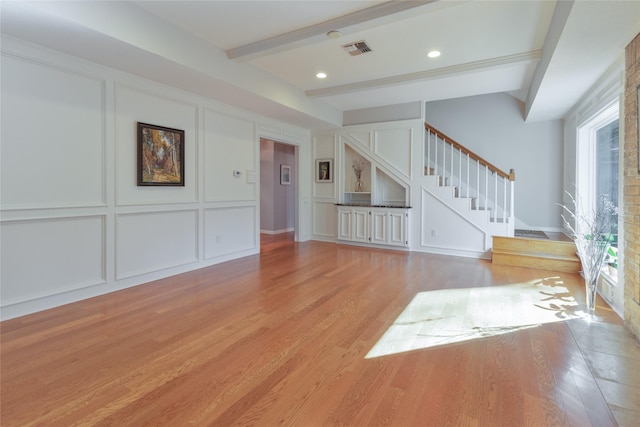 interior space featuring beam ceiling and light wood-type flooring