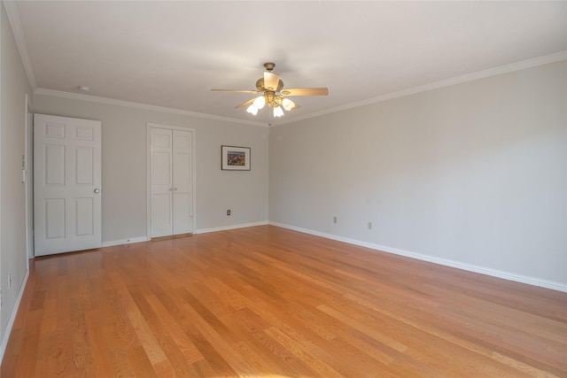 unfurnished bedroom featuring crown molding, a closet, ceiling fan, and light wood-type flooring