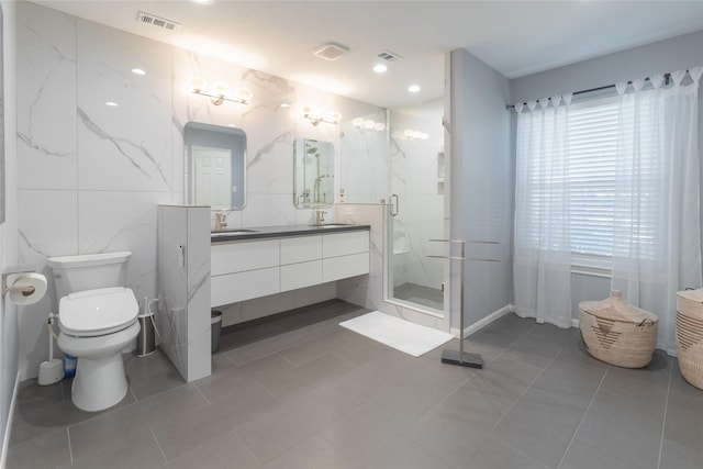 bathroom with tile patterned floors, vanity, toilet, and an enclosed shower