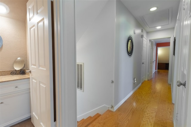 hallway with light hardwood / wood-style floors