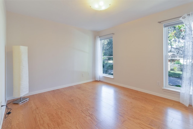 unfurnished room featuring plenty of natural light and light hardwood / wood-style floors