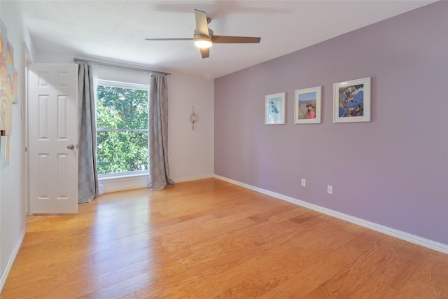 empty room with light hardwood / wood-style flooring and ceiling fan