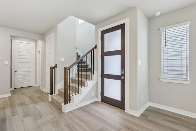 foyer entrance with light wood-type flooring