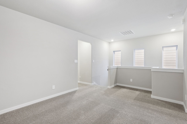 spare room with light colored carpet