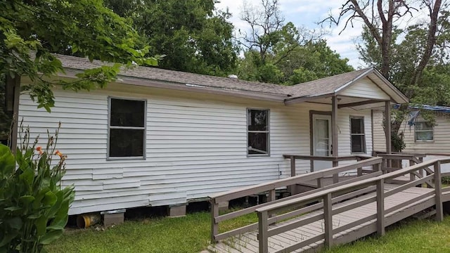 rear view of house with a wooden deck