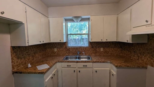 kitchen featuring backsplash, sink, white cabinets, and ventilation hood