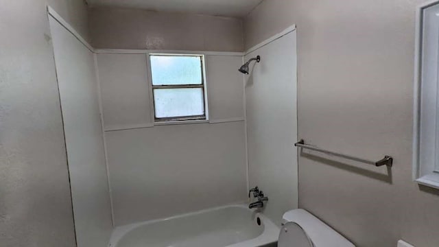 bathroom with toilet and washtub / shower combination