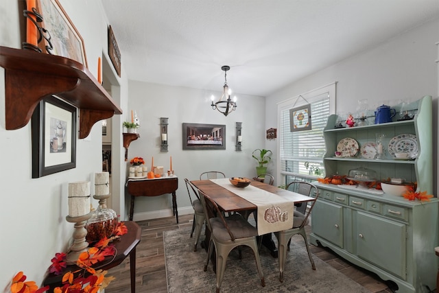 dining area with a chandelier and dark hardwood / wood-style floors