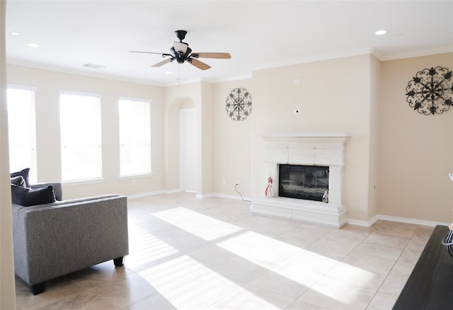 tiled living room with crown molding and ceiling fan