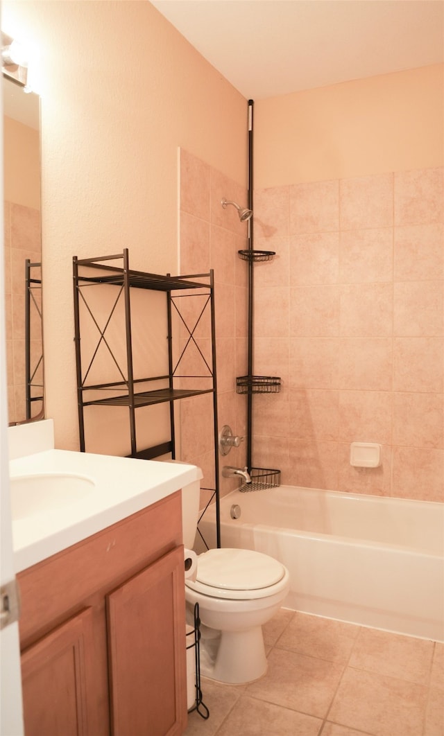 full bathroom featuring tile patterned floors, vanity, toilet, and tiled shower / bath combo