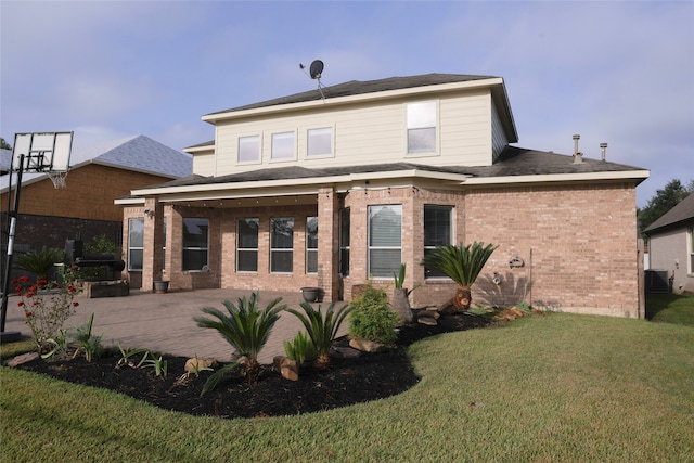 rear view of house with a yard and a patio