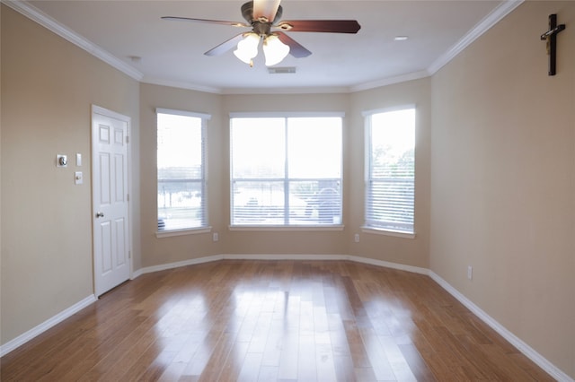 empty room featuring ceiling fan, ornamental molding, and light wood-type flooring