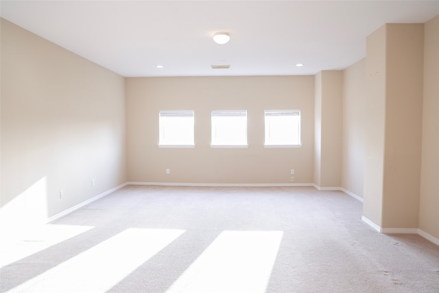 carpeted empty room featuring plenty of natural light