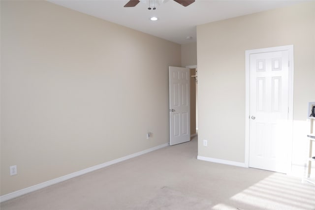 unfurnished bedroom with ceiling fan and light colored carpet