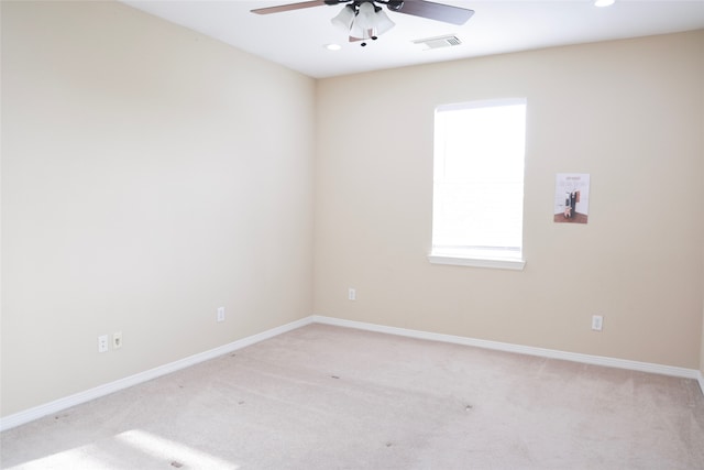 carpeted empty room featuring ceiling fan