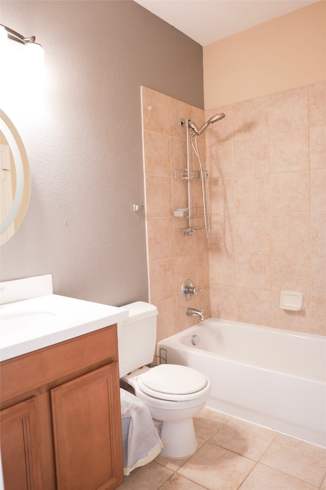 full bathroom featuring tile patterned floors, vanity, tiled shower / bath combo, and toilet