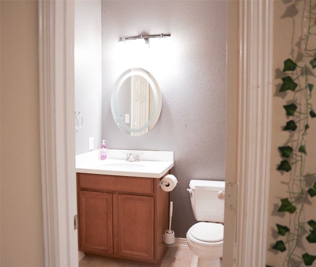 bathroom featuring tile patterned floors, vanity, and toilet