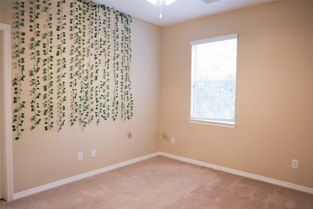 unfurnished room featuring light colored carpet