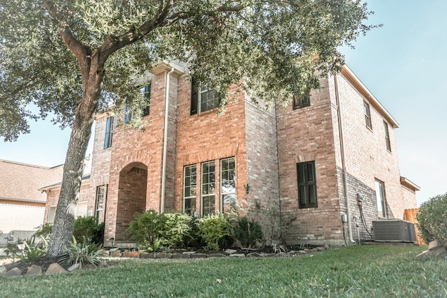 exterior space featuring a lawn and cooling unit