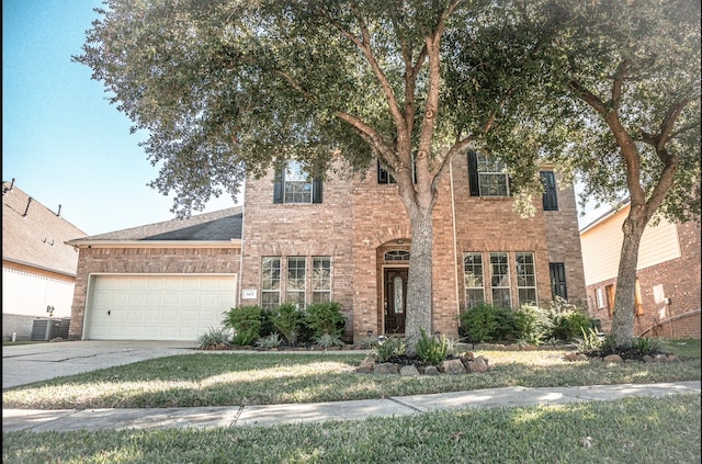 view of front of home featuring cooling unit and a garage