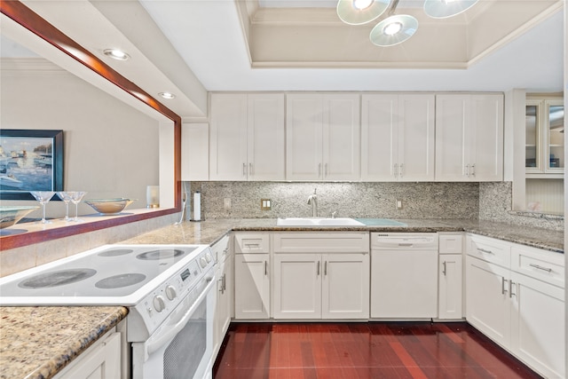 kitchen featuring white cabinetry, sink, tasteful backsplash, white appliances, and a tray ceiling