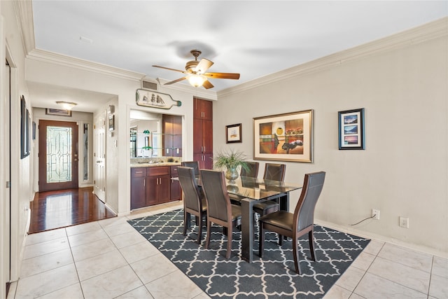 dining room featuring ceiling fan, ornamental molding, and light tile patterned floors