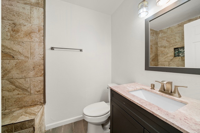 bathroom with vanity, hardwood / wood-style floors, and toilet