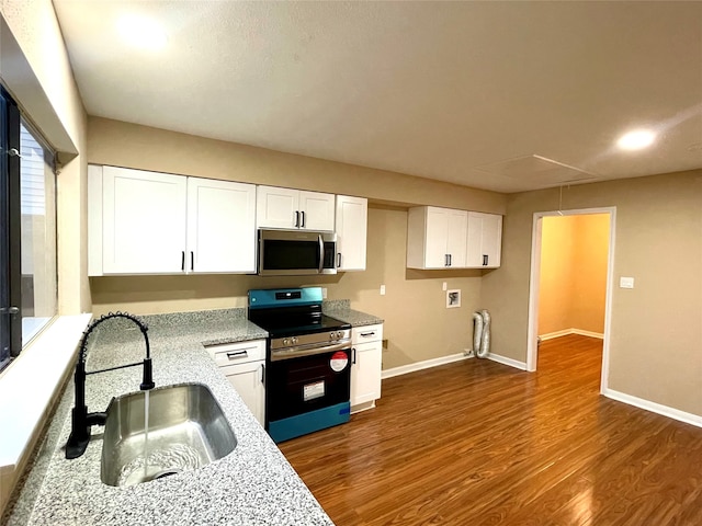 kitchen with dark hardwood / wood-style flooring, sink, white cabinets, and stainless steel appliances