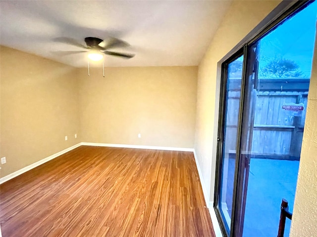 spare room with hardwood / wood-style floors and ceiling fan