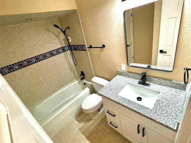 full bathroom featuring vanity, tile patterned flooring, tiled shower / bath, and toilet