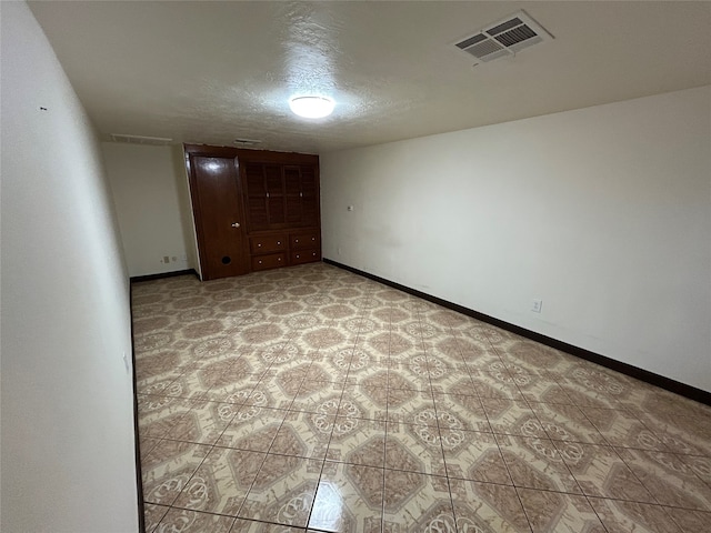 spare room featuring a textured ceiling